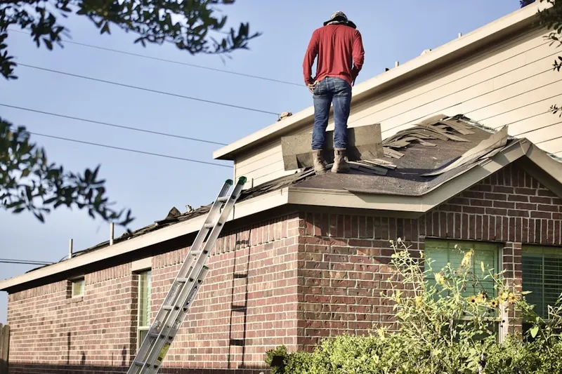 Professional roofer working on a residential roof in Dixie